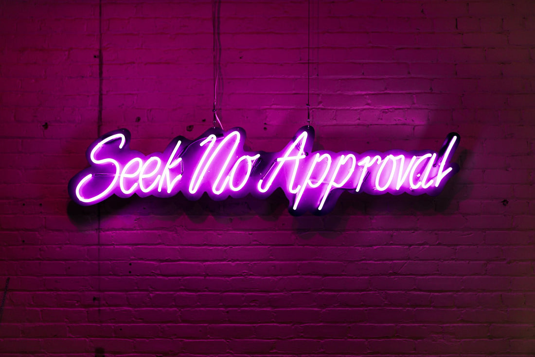 Neon sign that reads Seek No Approval