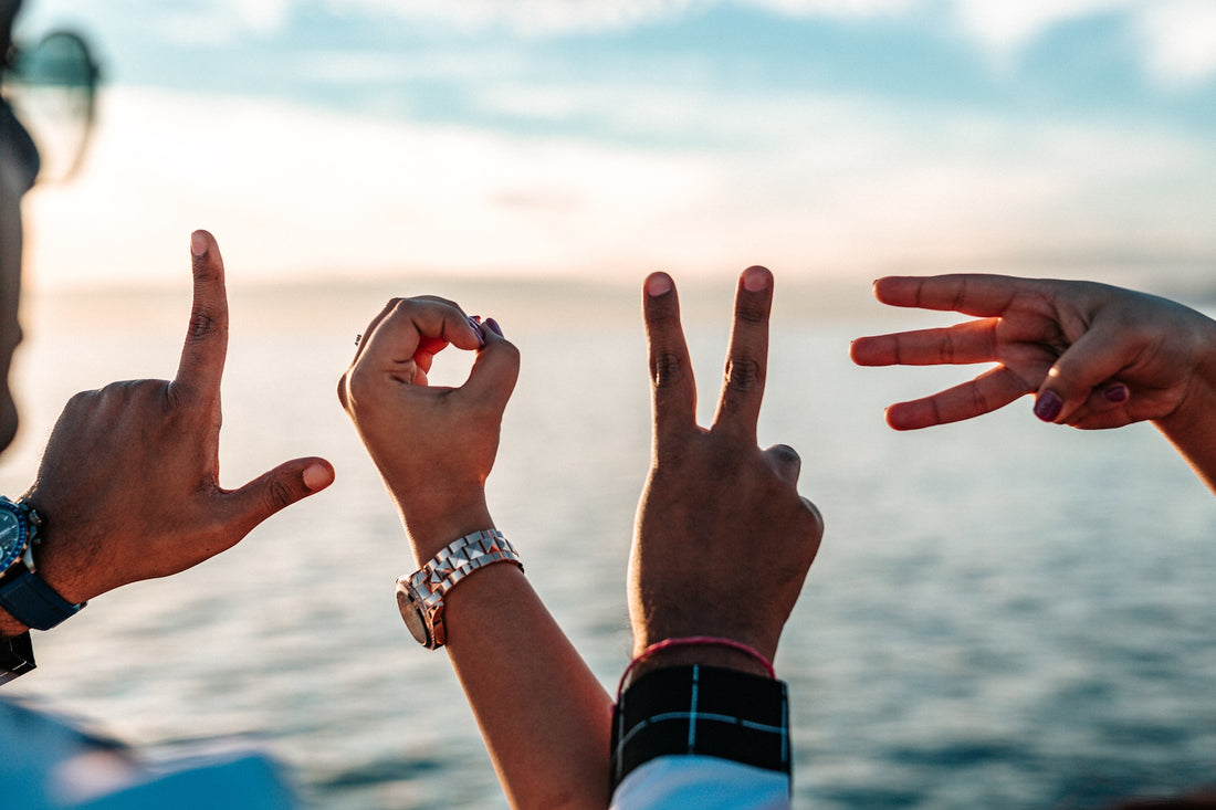 Hand gestures spelling out LOVE - Photo by Tyler Nix on Unsplash